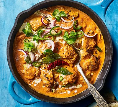 Curry recipes Butter chicken in pot with blue background