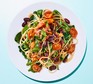 A plate of spaghetti with kidney beans, spinach, tomatoes and olives