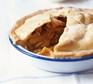 Apple pie in a baking dish, with slice taken out