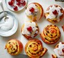 Belgian buns with icing and maraschino cherries