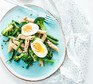 A plate of broccoli pasta salad with eggs & sunflower seeds