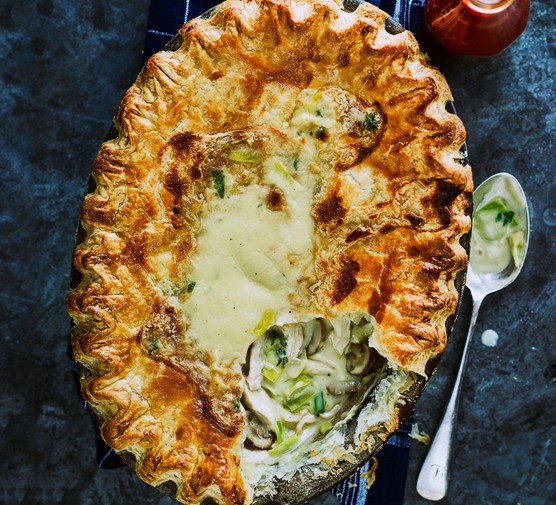 Chicken and leek pie Chicken and leek pie with a crimped pastry top with a spoon taken out