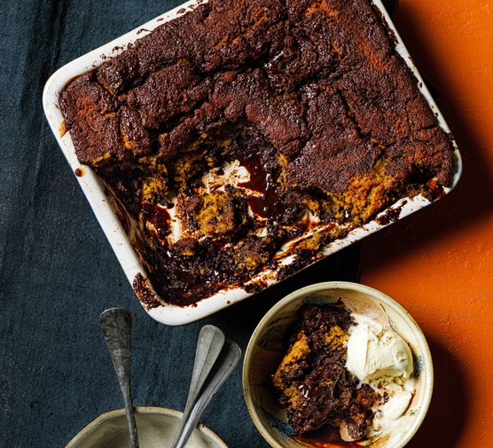 Chocolate sticky toffee pudding Chocolate sticky toffee pudding in a baking dish and bowl with ice cream