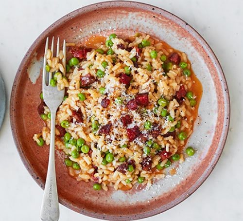Storecupboard comfort food Chorizo and pea risotto served on a plate