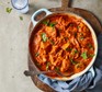 Creamy tofu curry with homemade roti in a casserole dish