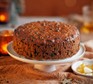 Dark & stormy fruit cake on a cake stand