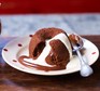 Chocolate fondant on a plate with molten centre oozing out