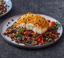 Harissa-crumbed fish with lentils, olives & peppers served on a plate