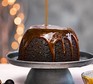 Jamaican ginger sponge pudding served on a cake stand