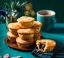 A selection of mince pies stacked on a plate