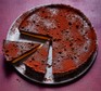 Dark chocolate and passionfruit tart with two slices cut out