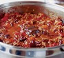 Chilli con carne cooking in a pan with chocolate melting on top