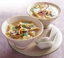 Chicken noodle soup in bowls with spoons