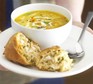 Roast chicken soup in a bowl with crusty bread