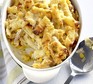Tuna pasta bake in an oval baking dish with portion out