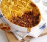Ultimate shepherd's pie in a dish with a portion gone