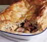 Chicken & mushroom puff pie with portion taken out