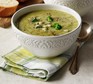 Broccoli and stilton soup in a patterned bowl with napkin & spoon