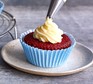 One red velvet cupcake with buttercream icing piped on the top