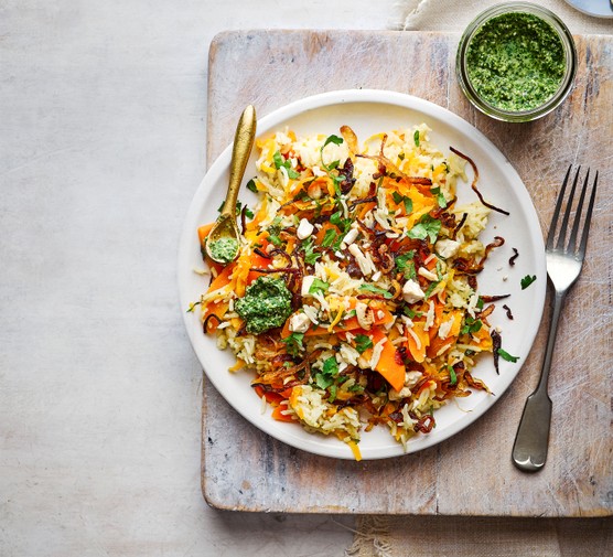 Carrot pilaf on a plate next to chutney