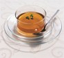 Chicken broth served in a glass cup and saucer