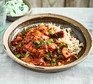 A dish of slow-cooked chicken curry with brown rice