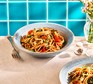 Spaghetti with tomatoes & walnuts in a bowl