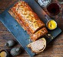 A Toulouse sausage roll on a serving board