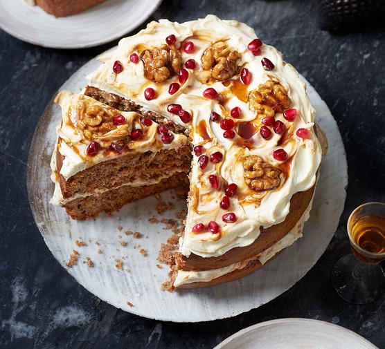 Winter cake recipes Spiced cake covered in icing, pomegranates and walnuts